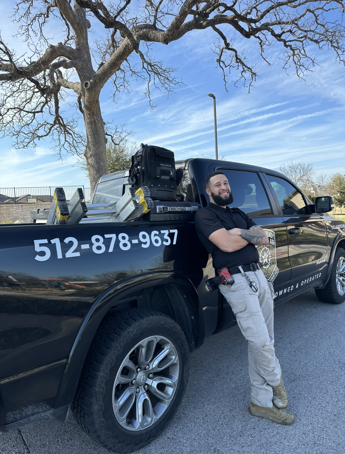 Enmanuel Rodriguez leaning on branded service truck
