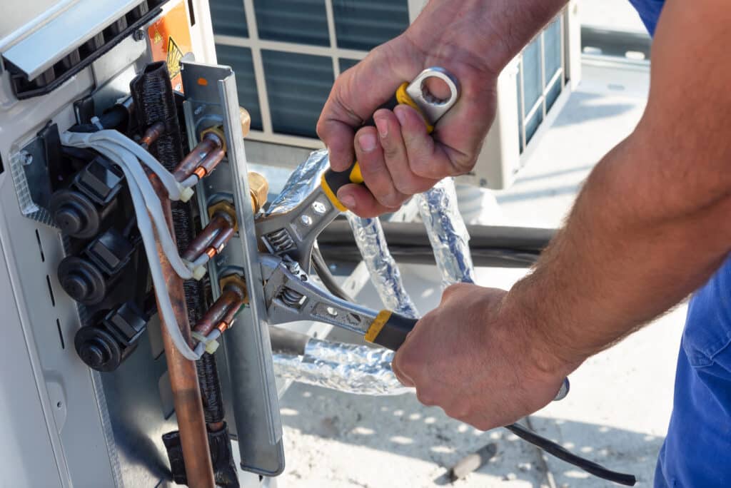 AC technician installing a new unit