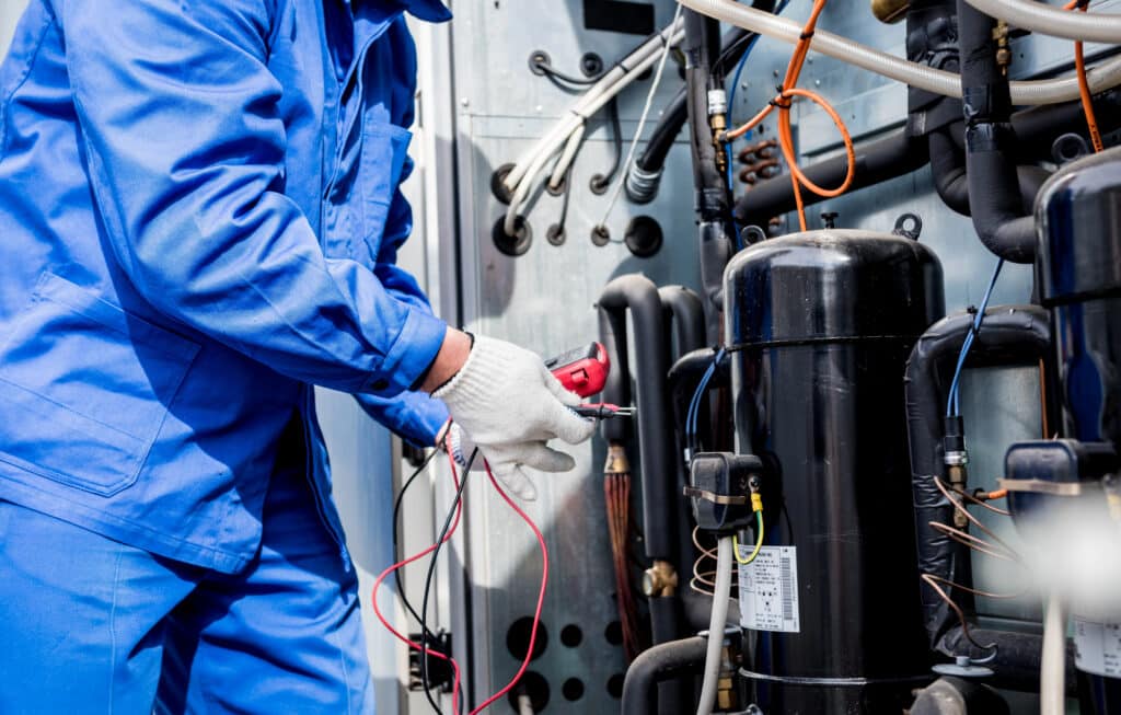 HVAC technician fixing a machine