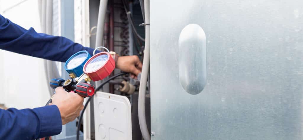 AC technician checking levels